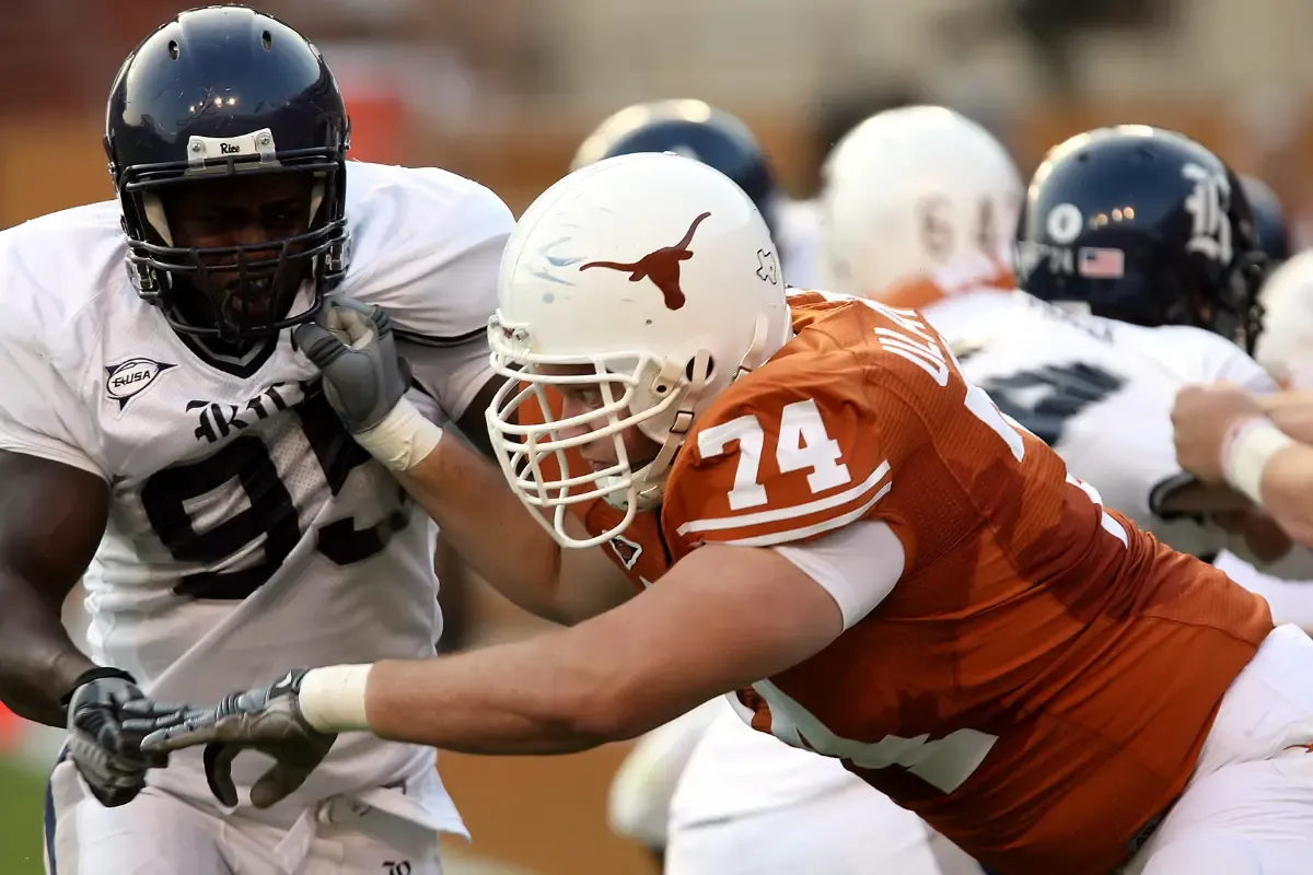 College football linemen battling on the field during a competitive game