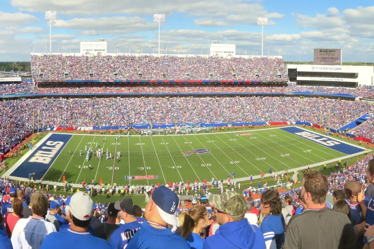 NFL game theory picks showcased with a packed stadium of fans watching a live football matchup.