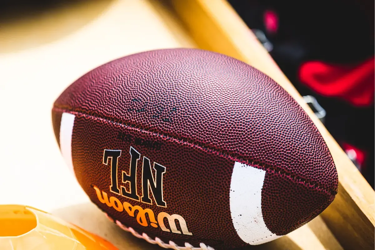 NFL-branded Wilson football placed on a wooden surface.