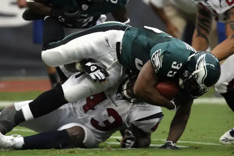 NFL playoff predictions action shot of players tackling during a game, showcasing intense competition